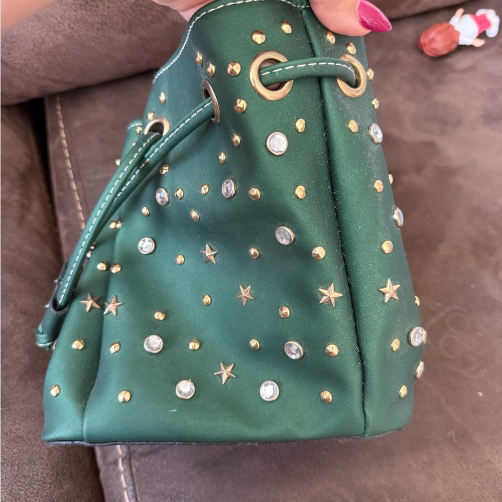Green bucket bag with golden studs